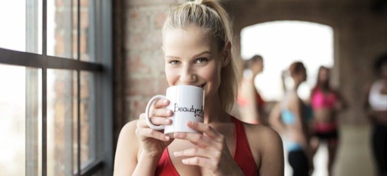 a woman drinking herbal teas that soothe muscle soreness after exercise